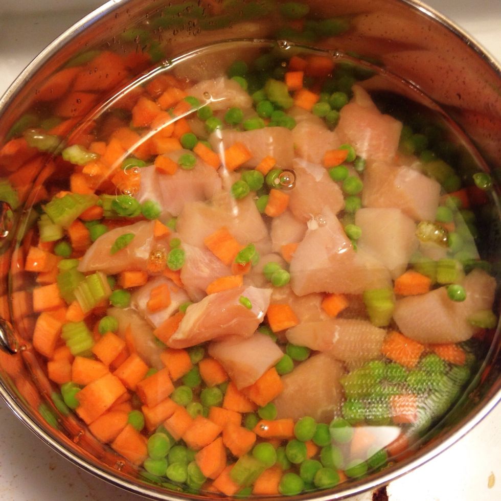 Place chicken, carrots, peas, and celery into a saucepan. Add just enough water to cover.