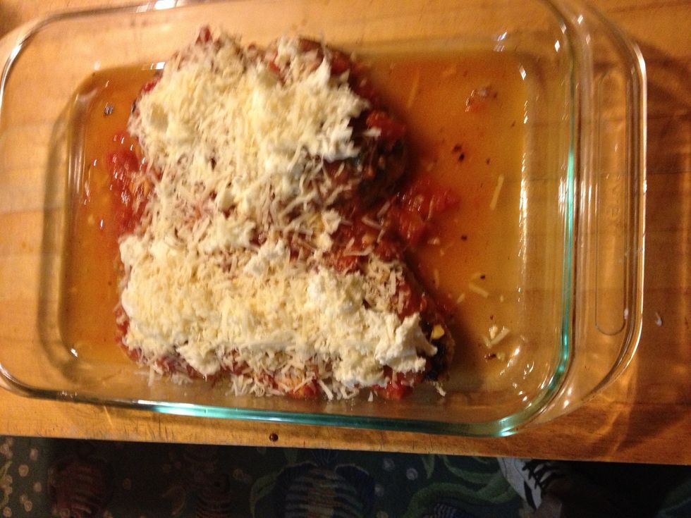 Place chicken in the pan and top with tomato sauce, Parmesan and mozzarella and cook at 350 for 10-15 min. just to brown the cheese. The chicken should be mostly already cooked,so don't over cook here