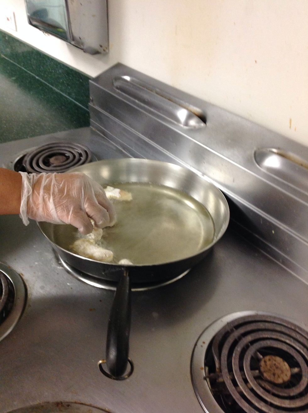 Place chicken into hot pan of oil