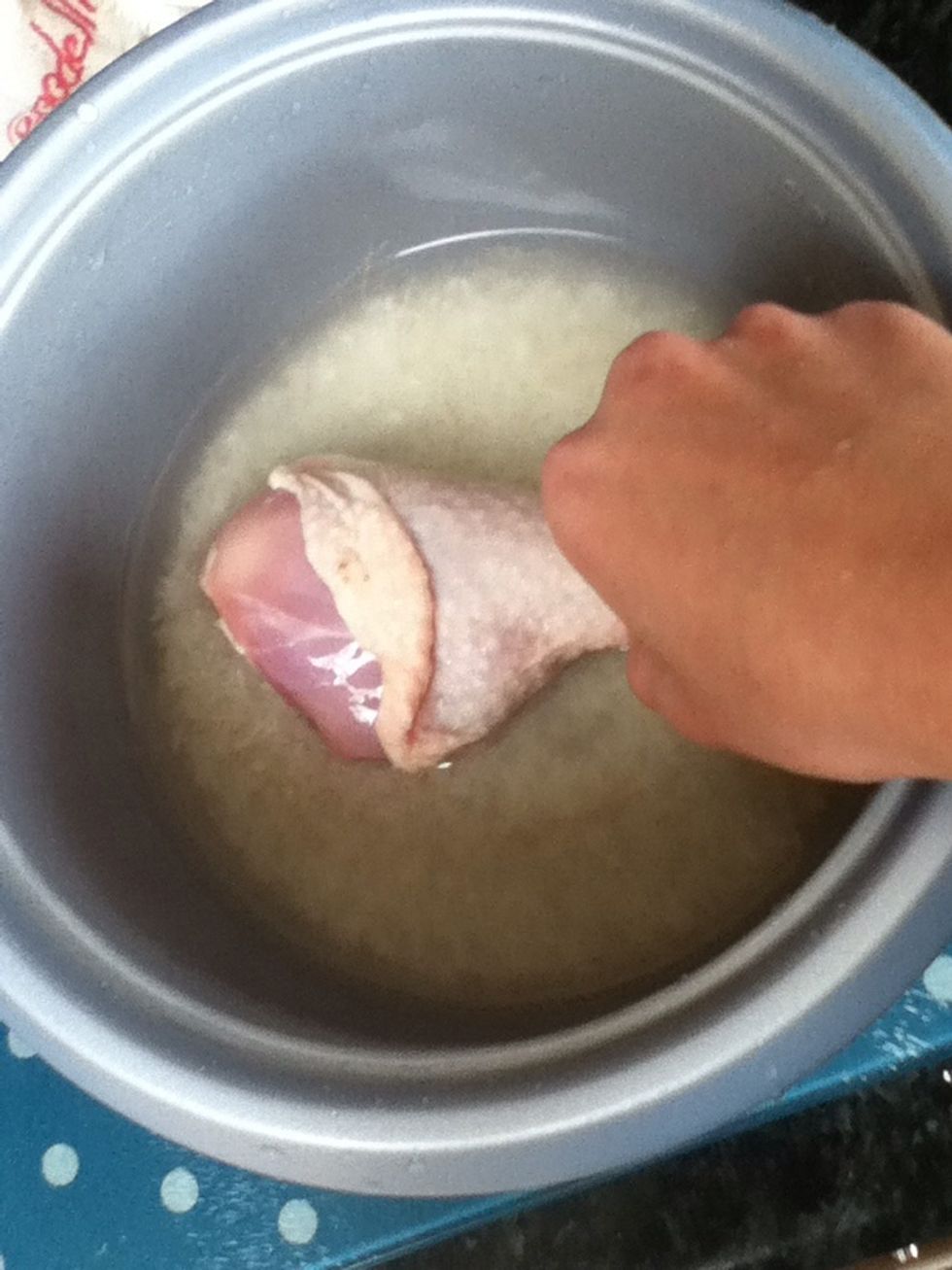 Place chicken into rice cooker with the rice. Together.