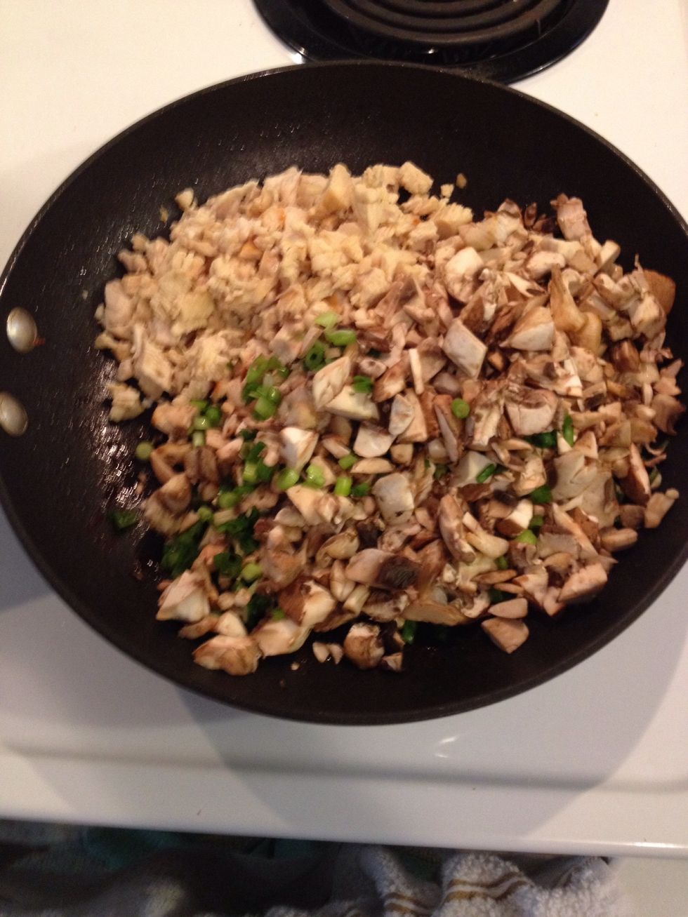 Place chicken, mushrooms and onions in a large skillet over medium heat until mushrooms and onions begin to soften.
