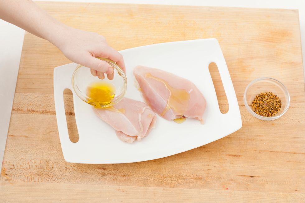 Place chicken on a plate and drizzle olive oil over both sides of your chicken.