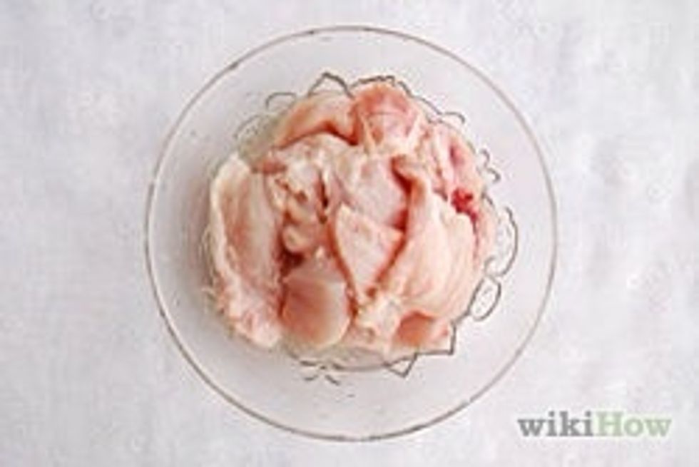 Place chicken pieces in a bowl.