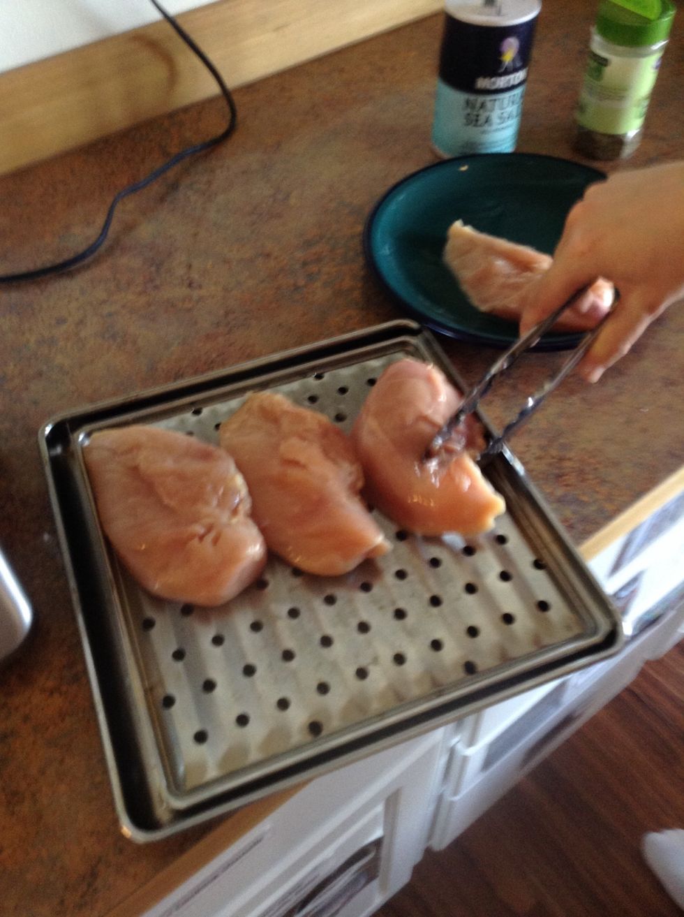 Place chicken seasoned side down on baking sheet