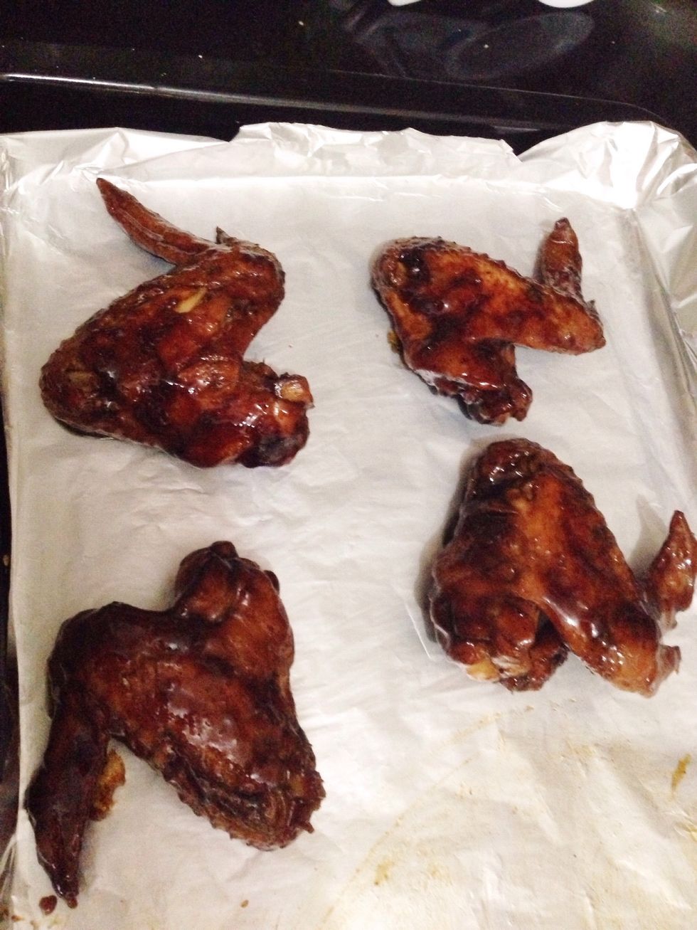 Place chicken to foil-lined baking tray. Actually you can already eat the chicken at this point, but I like to broil them for a while