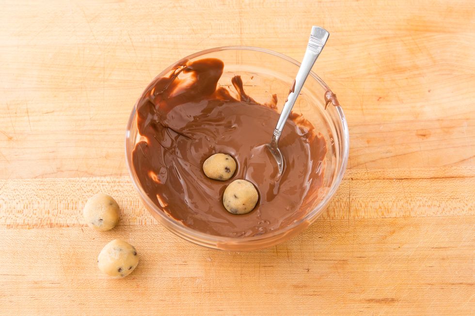 Place chocolate and coconut oil in a medium bowl and melt in the microwave, melting and stirring in 30 second intervals. Remove a few balls from the freezer at a time and coat in chocolate.