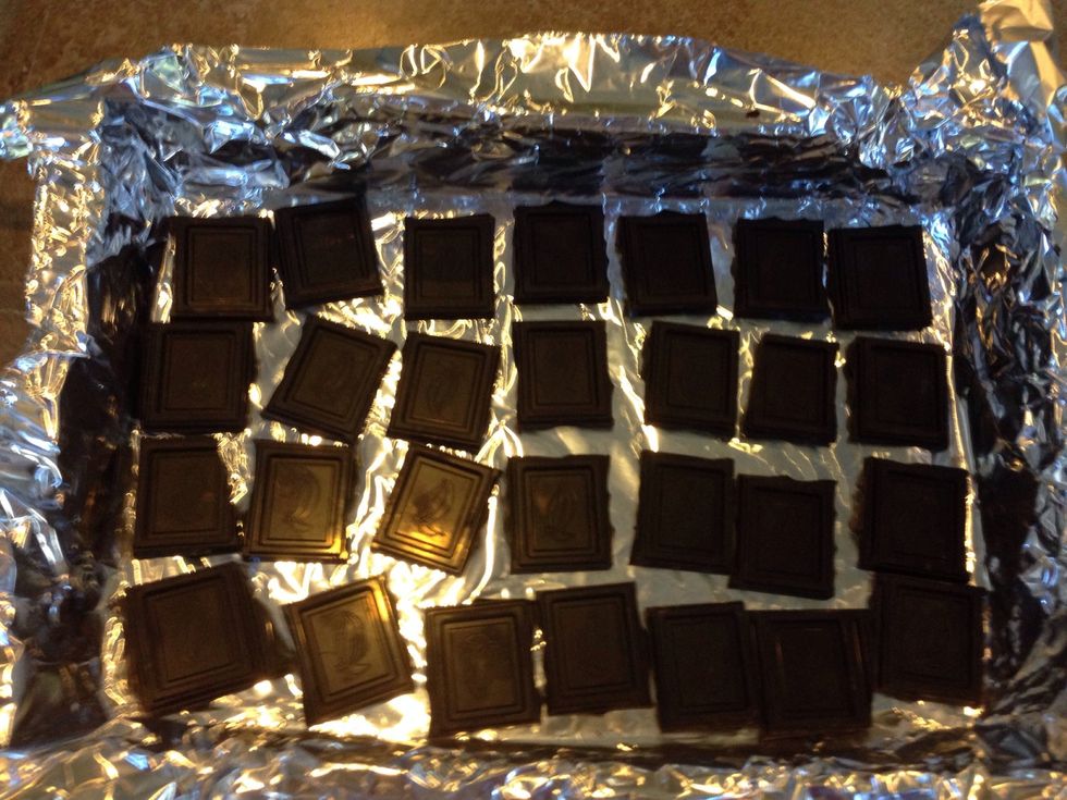 Place chocolate in an even layer on the foil. Place in oven for five minutes or until almost melted.