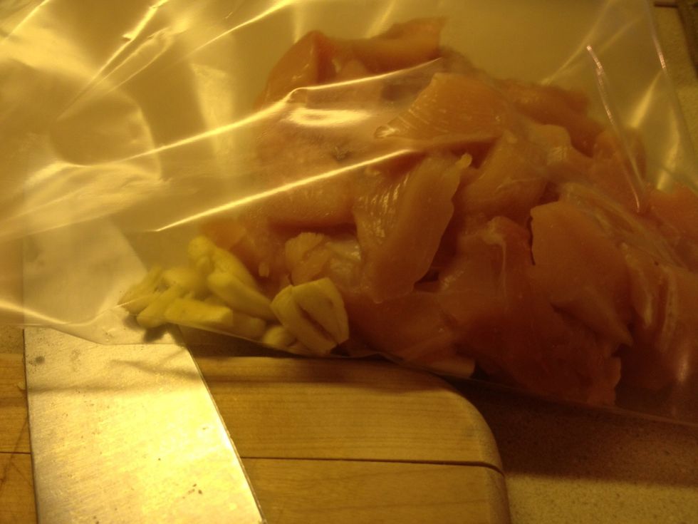 Place chopped chicken and garlic cloves in a zip lock bag and shake. This will give the chicken flavor. (If you leave the chicken whole rub the chicken with the garlic)