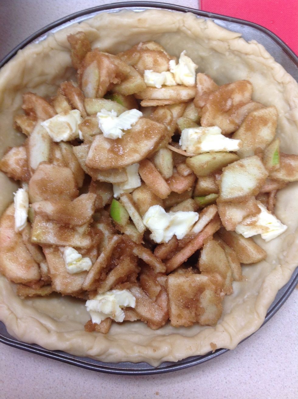 Place chunks of butter into apples, evenly spread