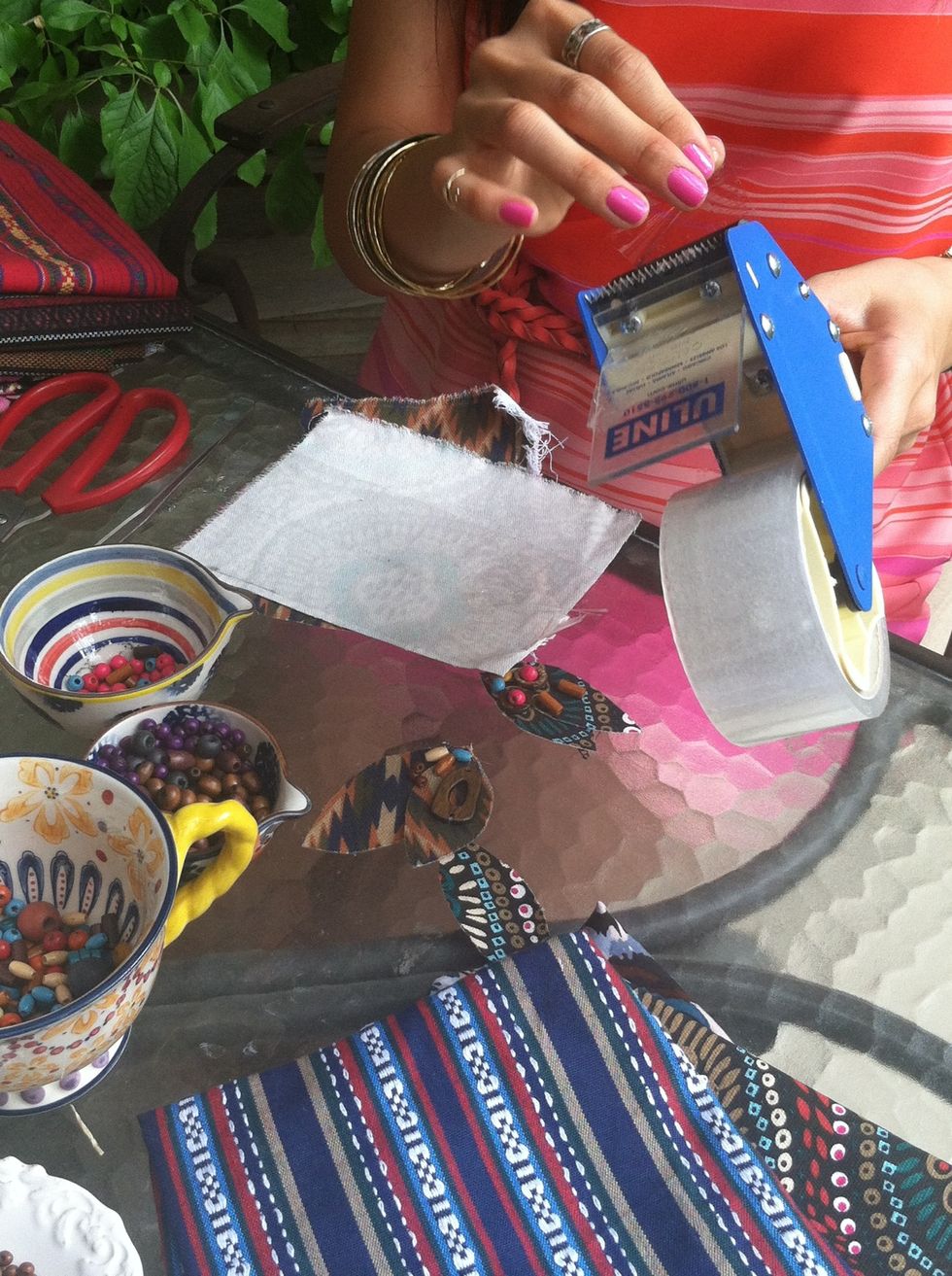 Place clear tape on the back of the fabric