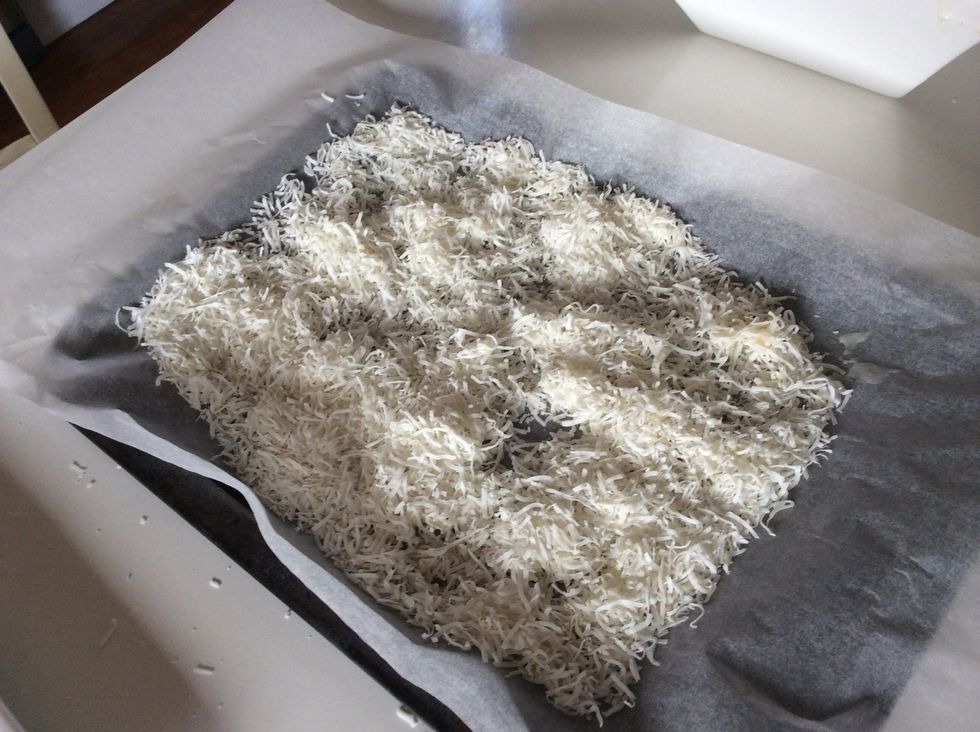 Place coconut into a tray