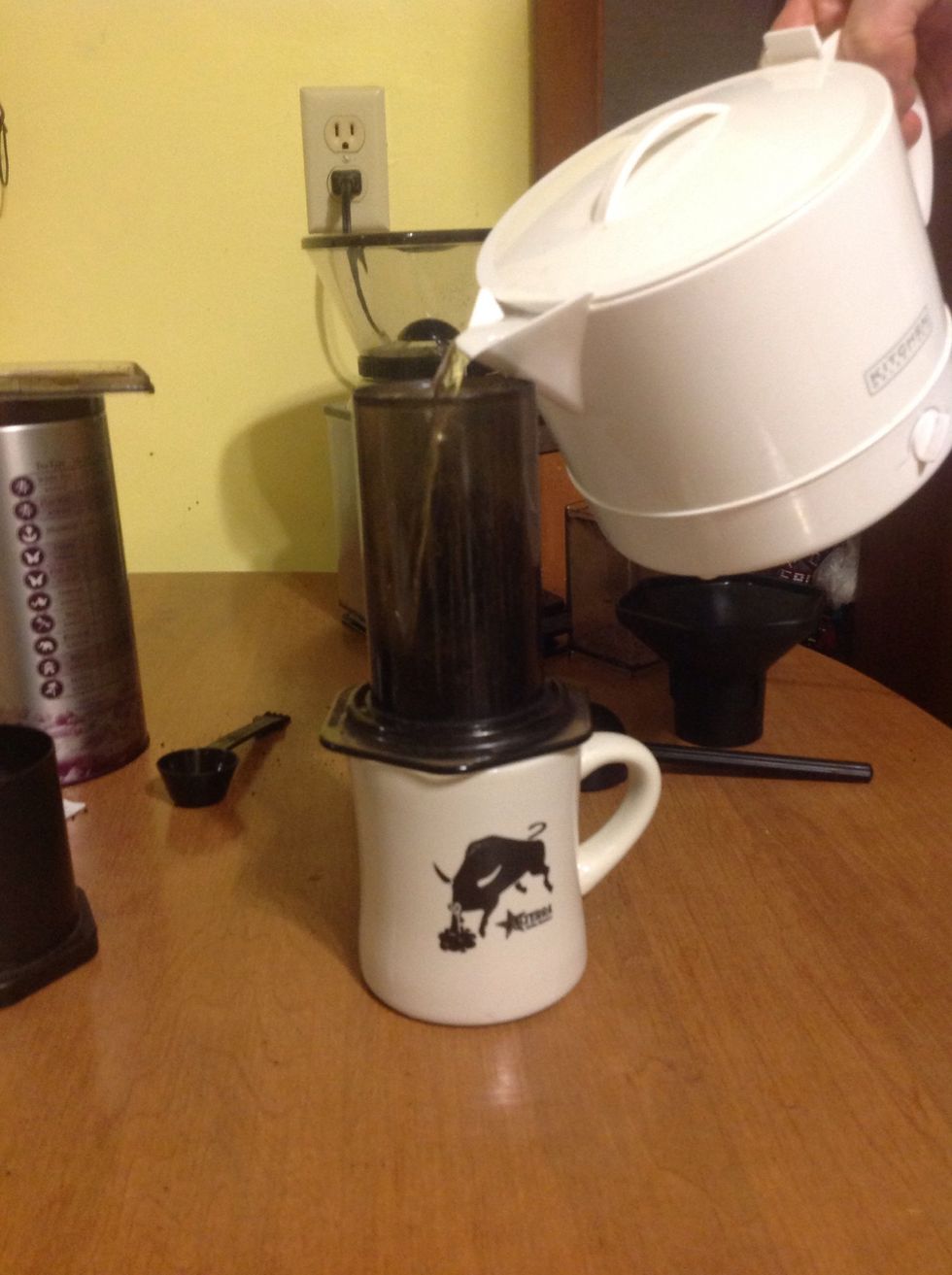Place coffee grounds into the cylinder, then pour the hot water on top of the coffee.