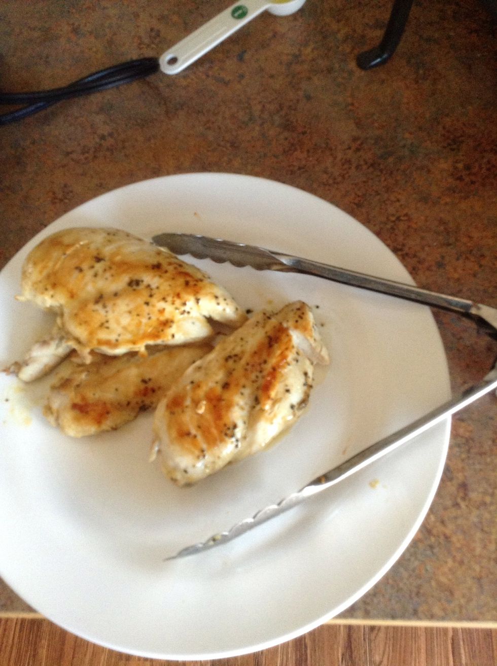 Place cooked chicken on a clean plate.