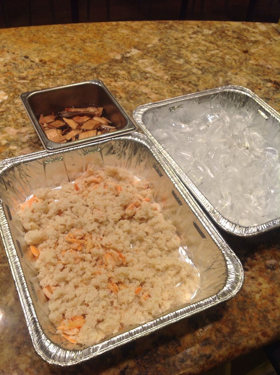 Place crab meat into a pan and have a pan of ice