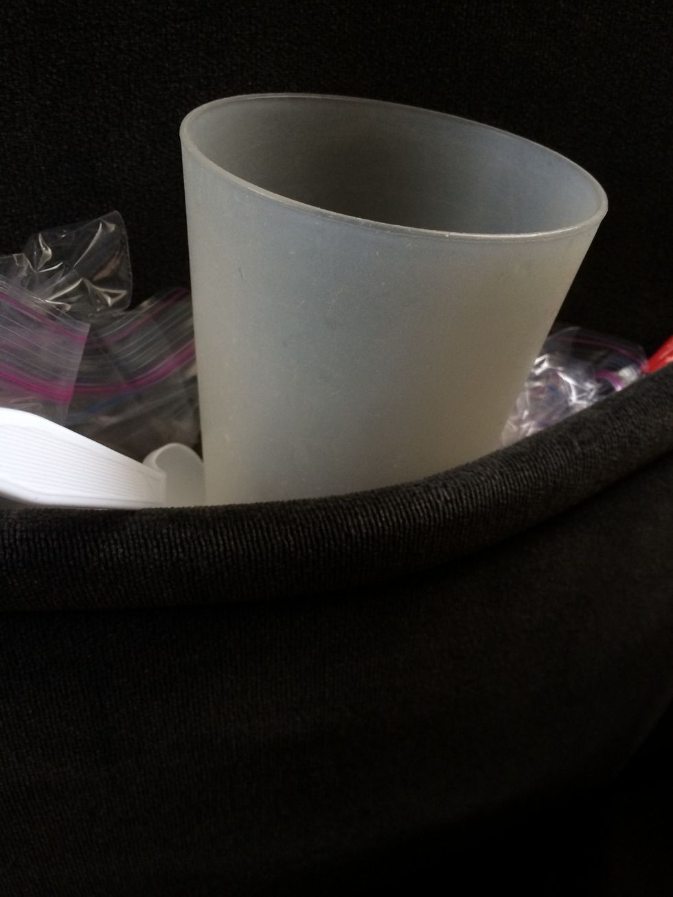 Place cup in the pocket inside the seat in front of you. (Consequently, if your car does not have seat pockets, this will not work. However, I could do a guide on how to make car pockets....hmm)