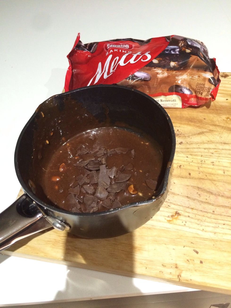 Place dark chocolate buttons into saucepan & melt.