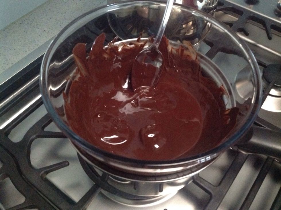 Place dark chocolate into a bowl over a saucepan of simmering water (make sure the bowl doesn't touch the water so the chocolate doesn't split). Stir with a metal spoon until the chocolate melts.