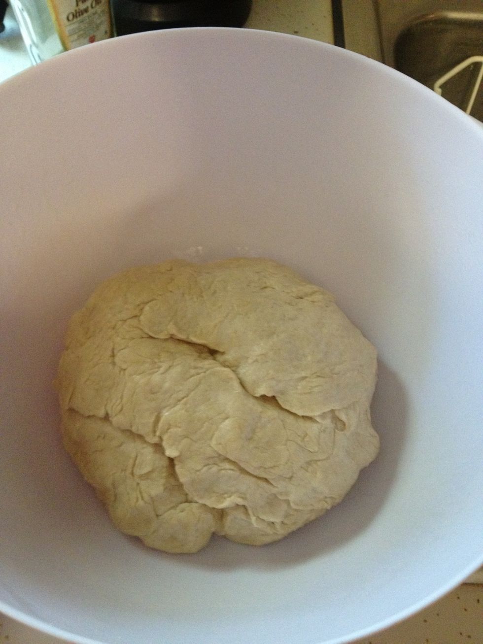 Place dough inside the greased bowl and roll it around until the dough is cover with oil.