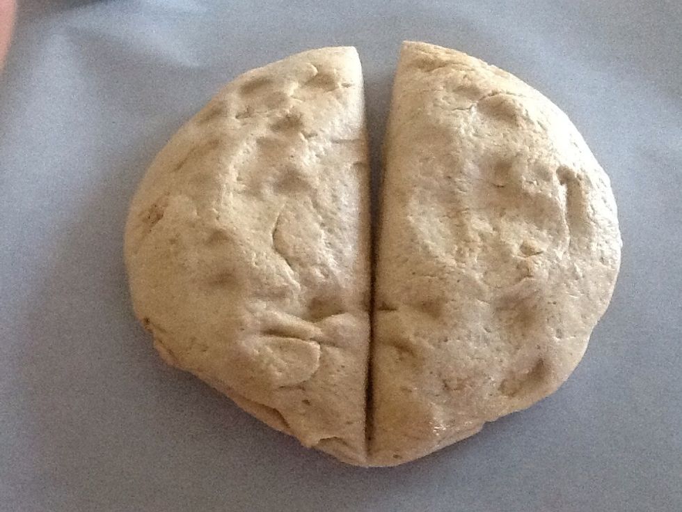 Place dough on a piece of parchment paper and divide into 2 pieces.