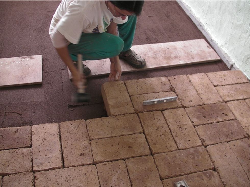 Place each brick, one by one, where you want it to go. Check it's level with previous bricks or existing floors, and that it's level in all directions. Tap with rubber mallet to get it perfect.