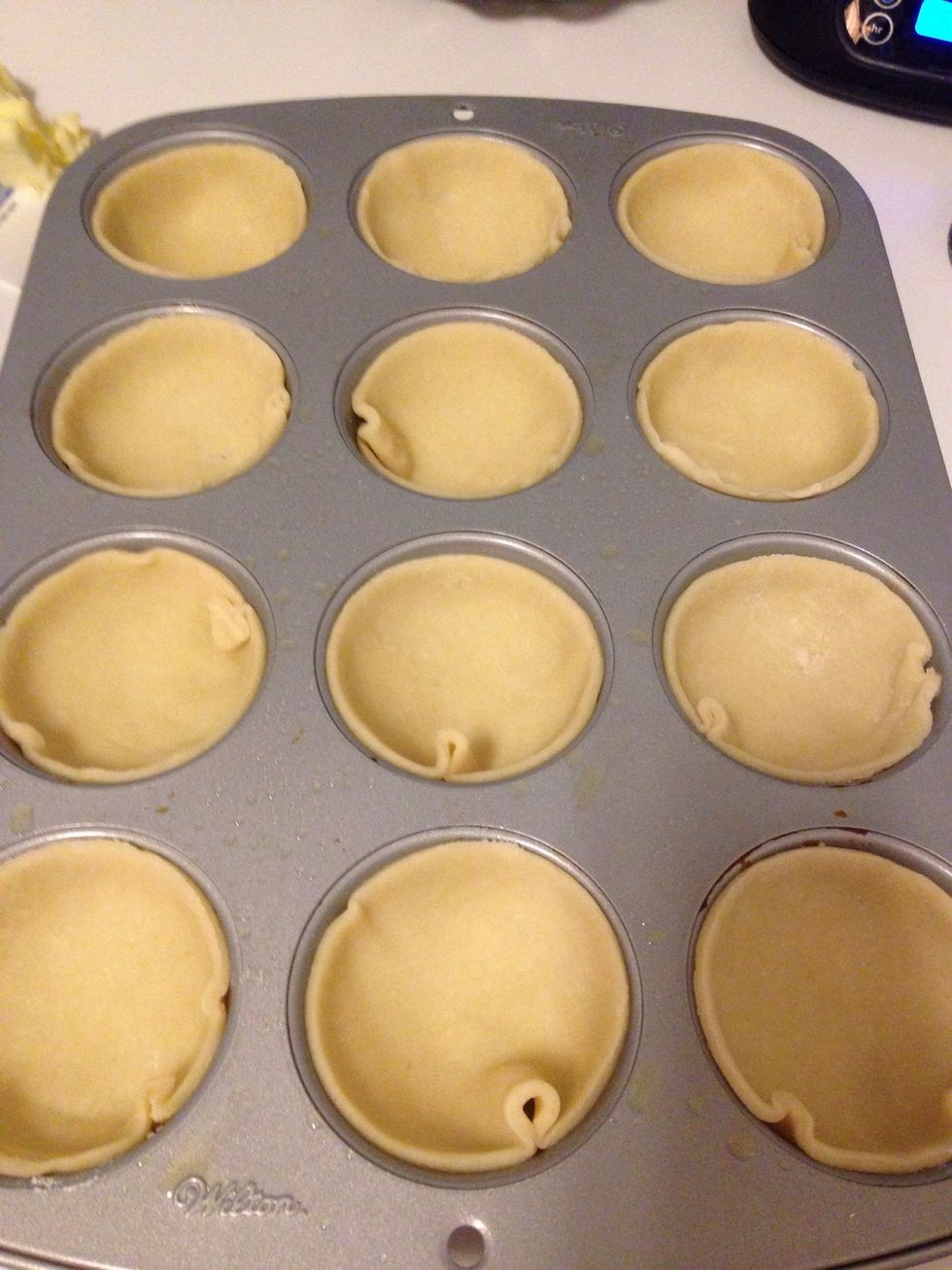 Place each circle of crust into the greased pan - place in fridge to stay cold until you're ready to fill. Use scrap crust to cut out a cute top for your pies! I made heart shapes for mine.