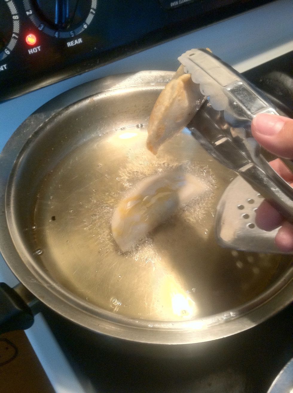 Place each empanada in the low - med heat and let fry on each side for about 1 min or until golden brown. (Repeat for each)