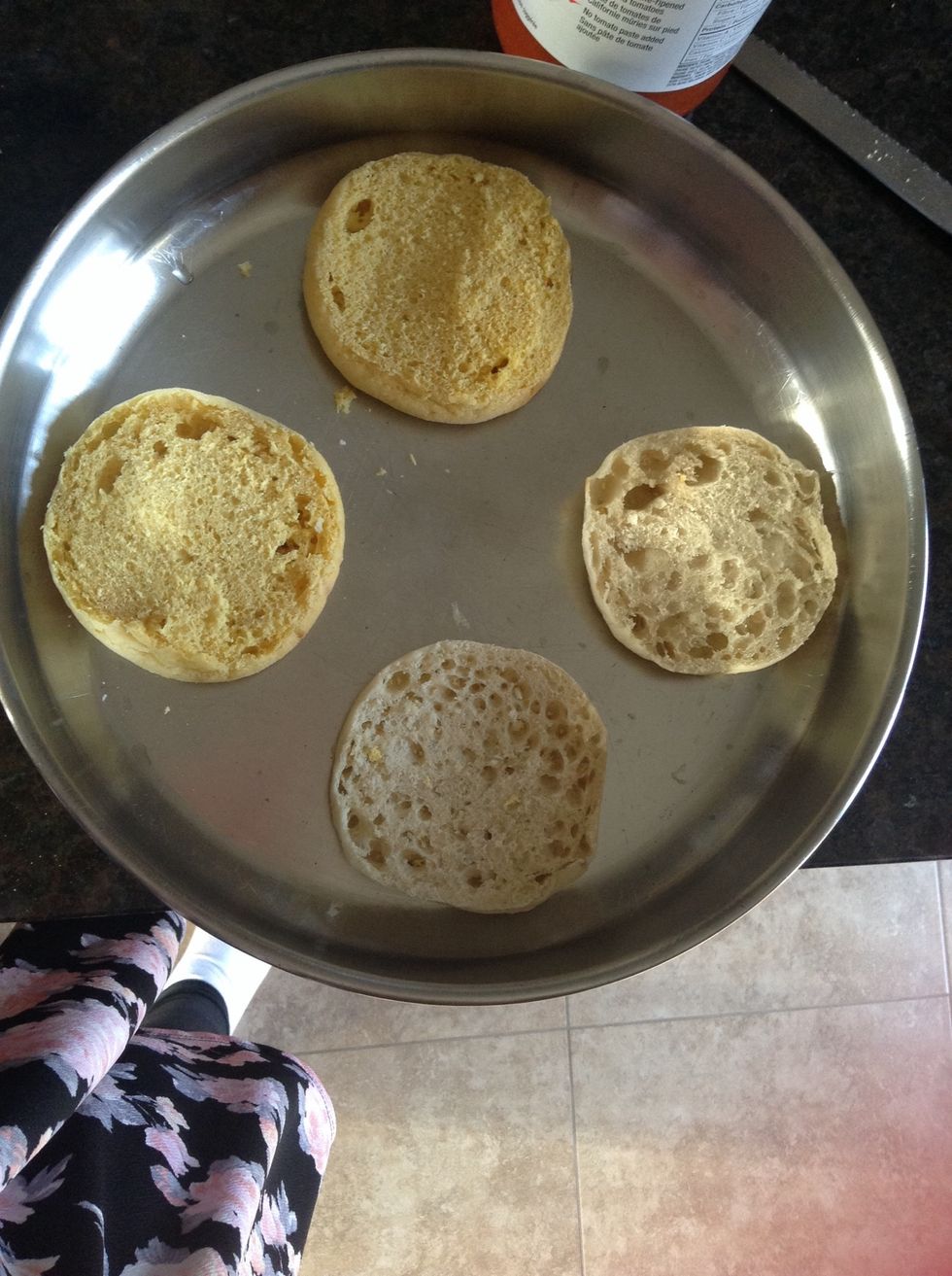 Place each English muffin halved with the sides you cut facing up onto an oven pan