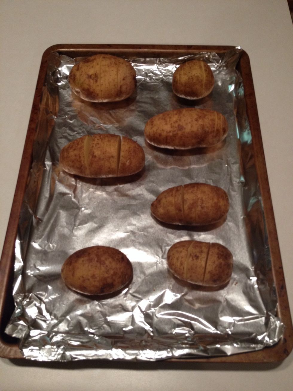 Place each potato on the baking sheet.