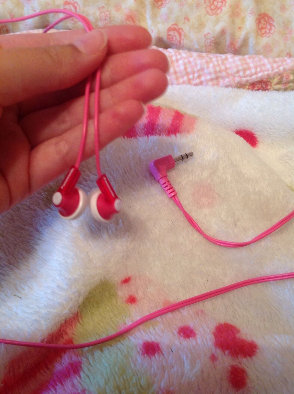 Place earbuds in your hand like so.