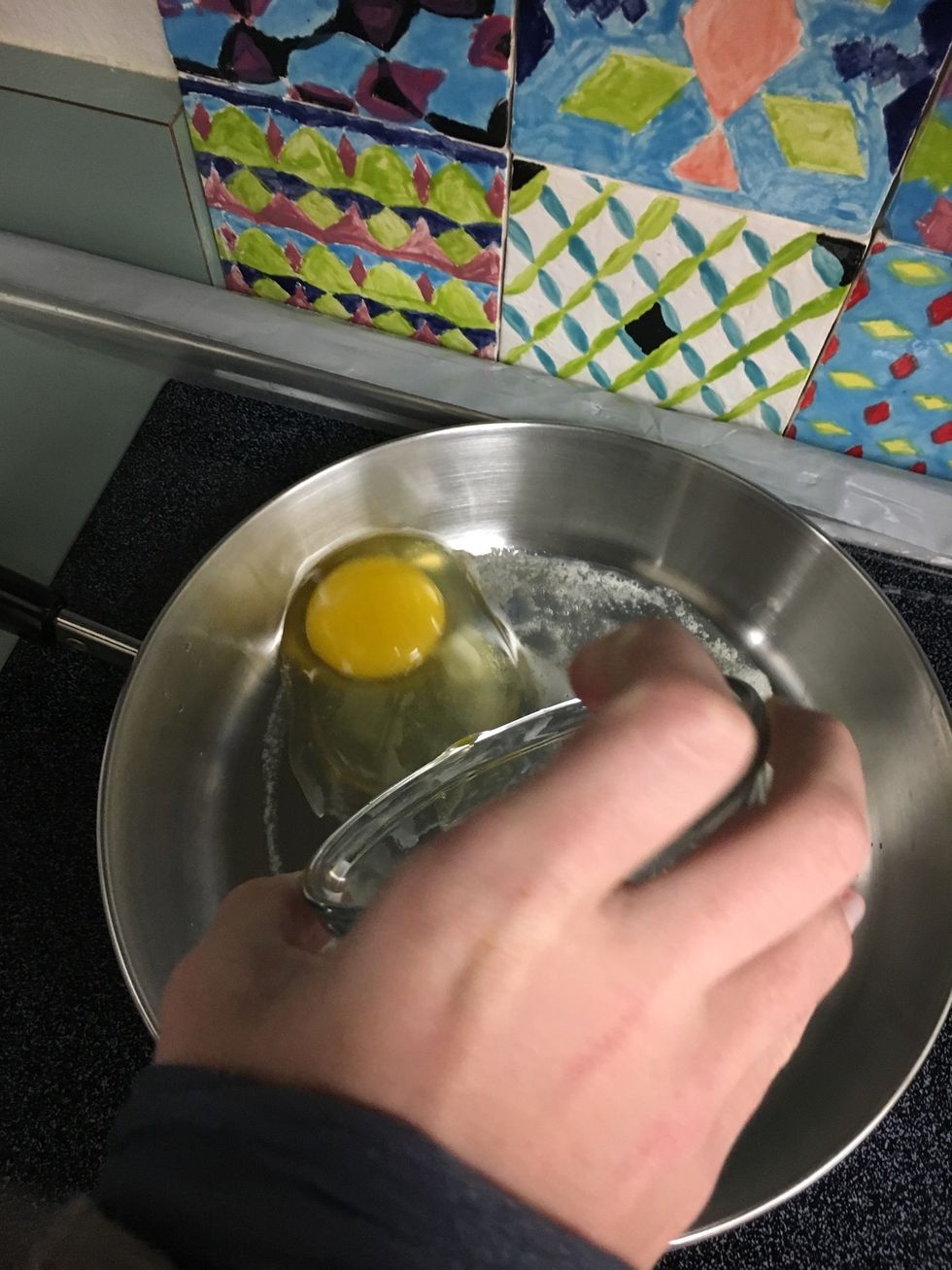 Place egg in custard cup into pan gently