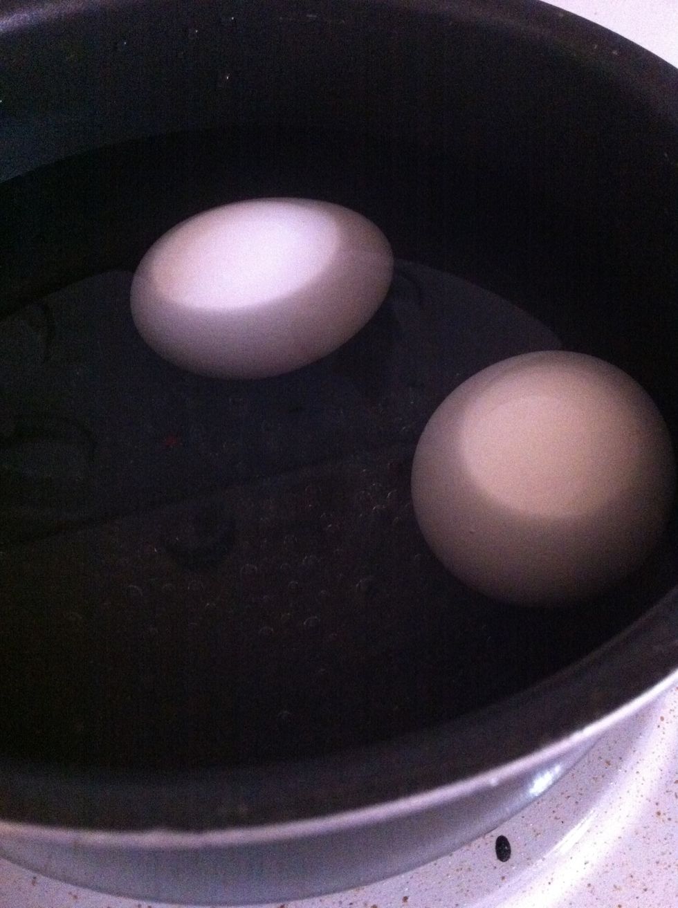 Place eggs in a pot & fill with water. You can use as many eggs as you'd like. Keep eggs in a single layer. Online suggests at least an inch over eggs. This amount has always done us fine.