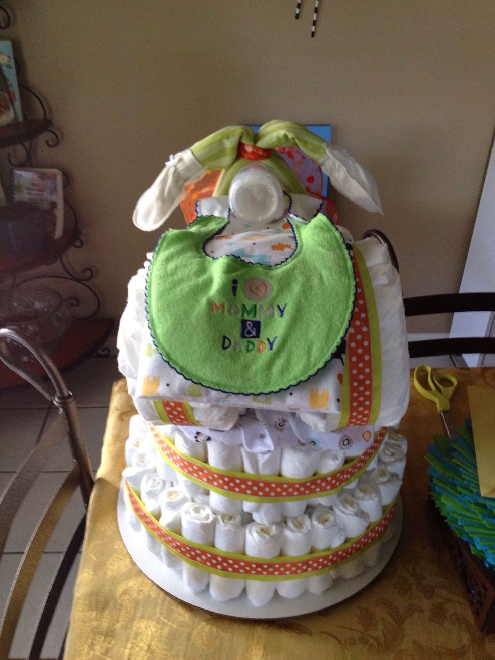 Place either socks or mittens to end of receiving blanket and either rubber band or tape.