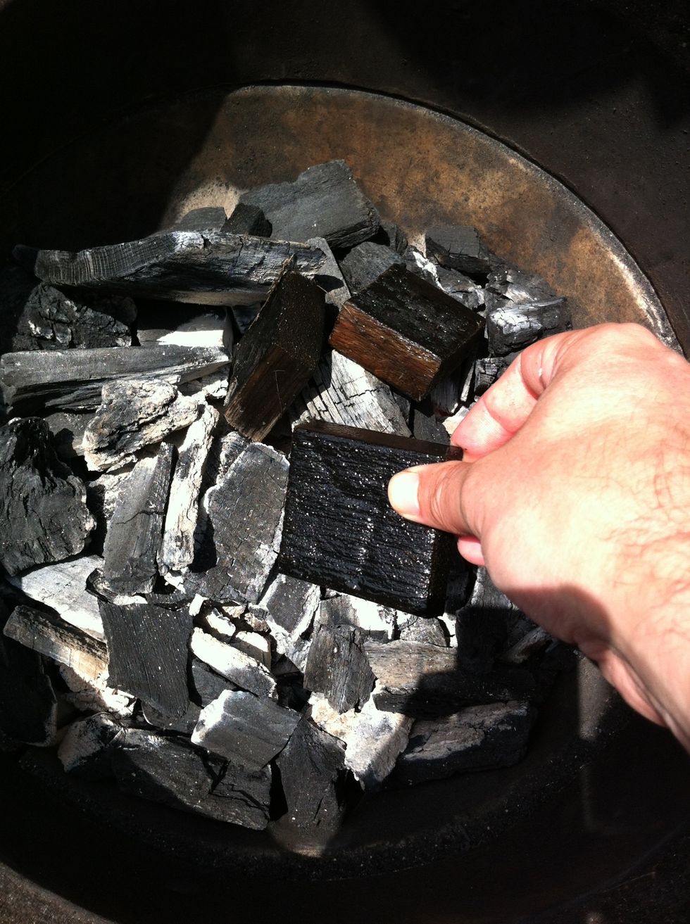 Place enough soaked chips or chunks to smoke for around 3 hours into hot charcoal. Stir in chips or chunks as best you can to ensure even 3 hour smoke.
