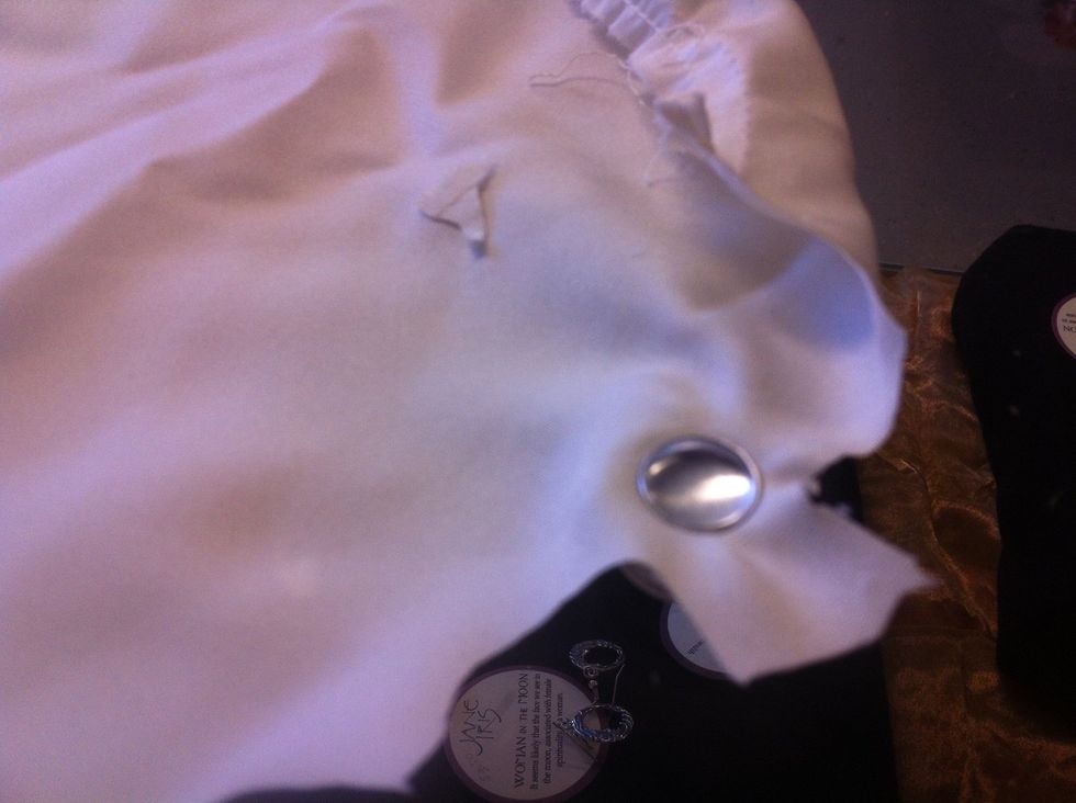 Place fabric right side down over the rubbery, cup part of the tool. Put the button part on top and press a little. Be sure to leave enough fabric around the edges to tuck inside the button shell.