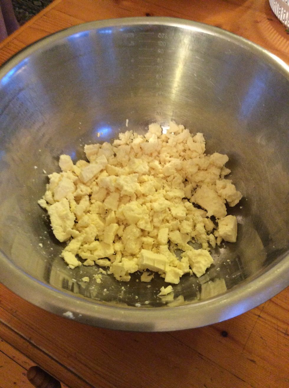 Place feta into a mixing bowl, and coarsely mash with a fork or crumble with your fingers.