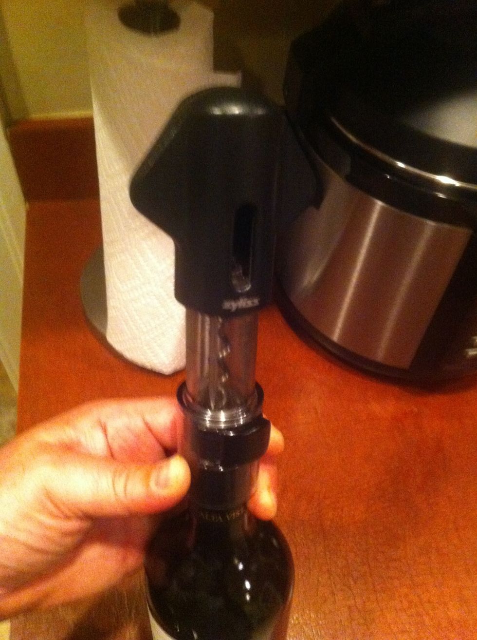 Place foil cutter over top of bottle using gentle supportive suggestions that it won't hurt at all