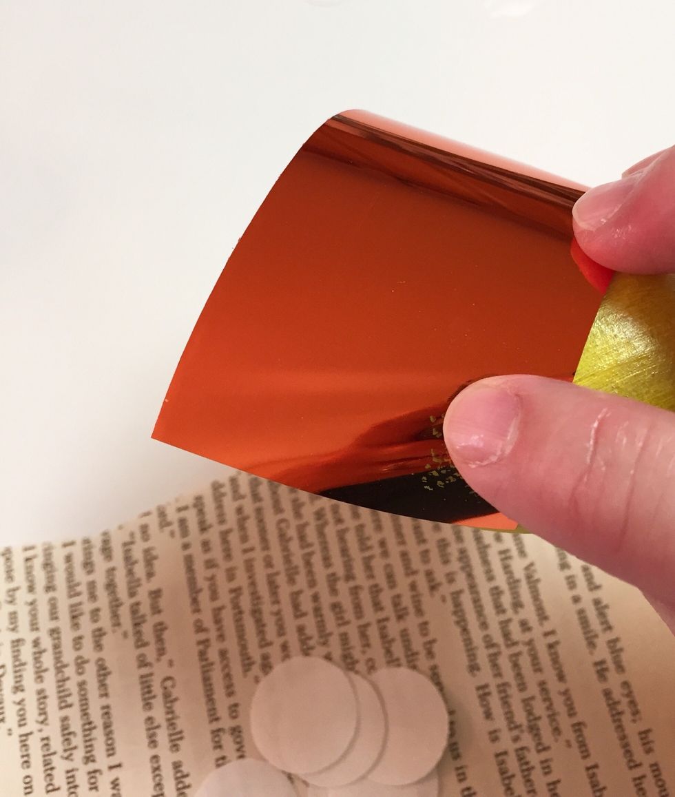 place foil sheet over adhesive dot and rub with your finger to transfer foil.