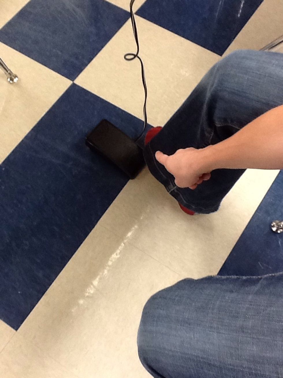 Place foot pedal on the ground in front of your right foot