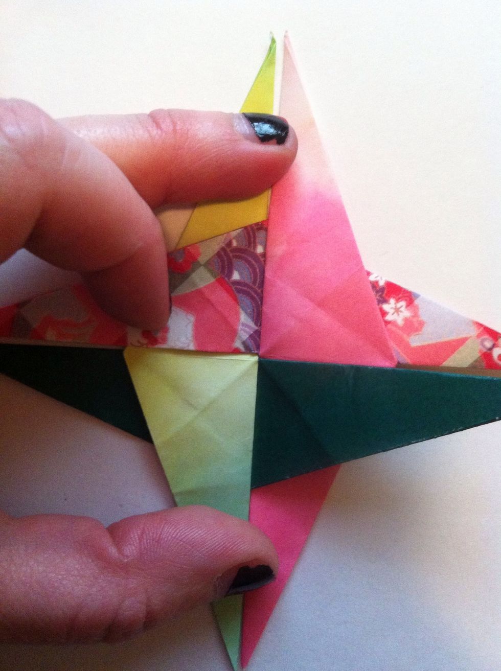 Place fourth one as shown (under pink; over green).