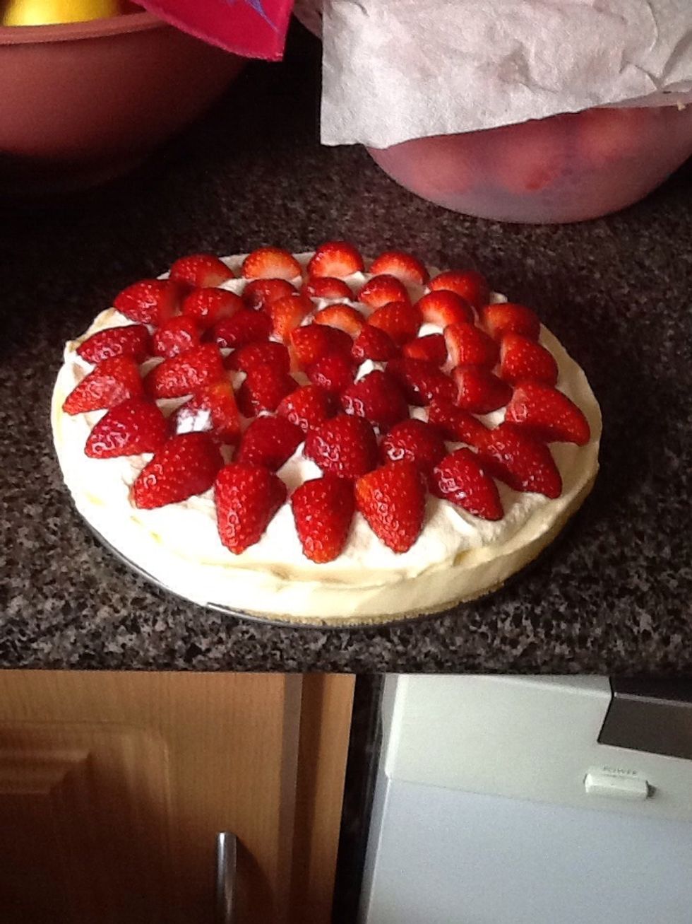 Place fresh washed and chopped strawberries onto cake