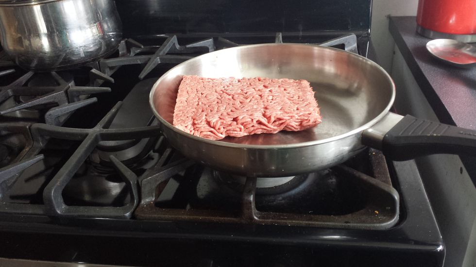 Place frying pan on stove then take the meat out of the container. After you have taken out the meat place on frying pan. Next turn heat on to medium on stove!