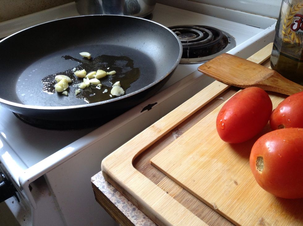 Place garlic in preheated olive oil; let brown lightly