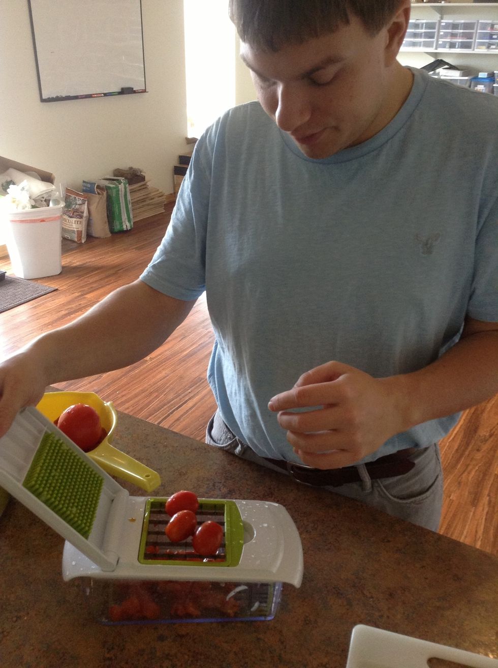 Place grape tomatoes on chopper and quickly press the handle down to dice the tomatoes