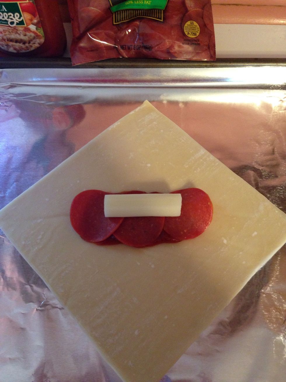 Place half a cheese stick on top of pepperoni. Now you can add any seasonings you would like. I did Italian seasoning and crushed red pepper.