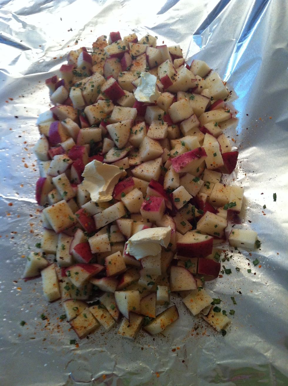 Place half of potatoes on foil and add seasonings by holding bottles horizontally and starting at toplightly shaking as you go down the pile and add half butter. Sorry I don't have measurements.