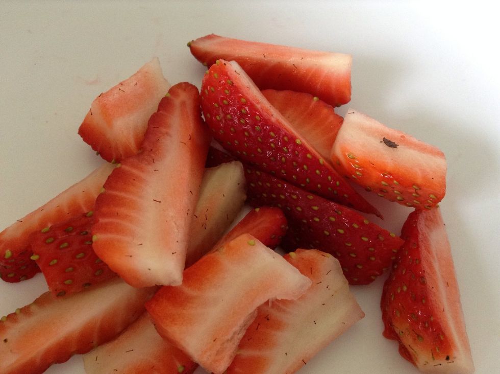 Place half of your chopped strawberries or other berries in a bowl.