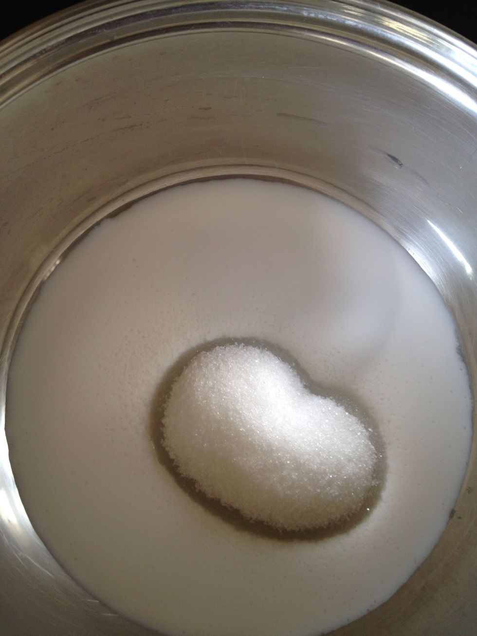 Place half the coconut milk and the sugar in a pan and stir on a medium heat until the sugar dissolves.