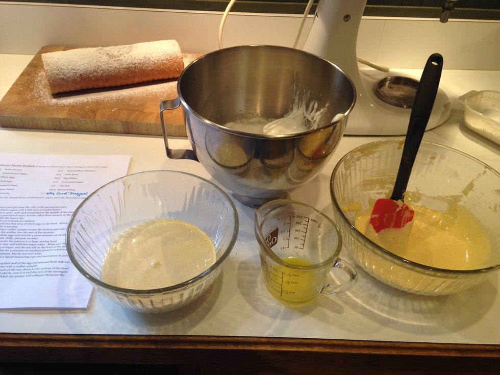 Place half the flour batter in a large mixing bowl. Add half the meringue and the melted butter.