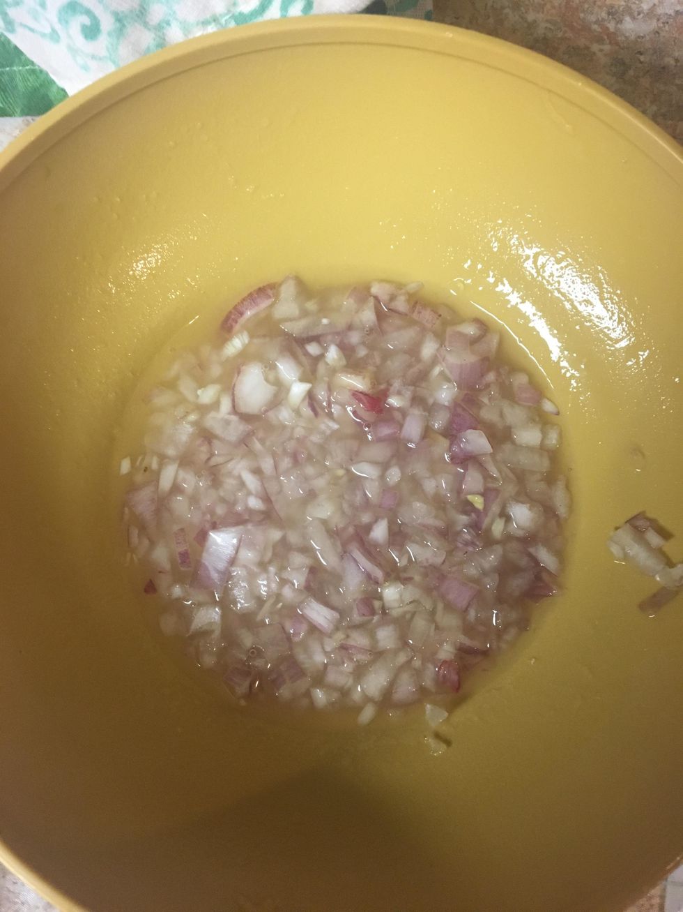 Place half the garlic in a small bowl with 1 teaspoon of olive oil