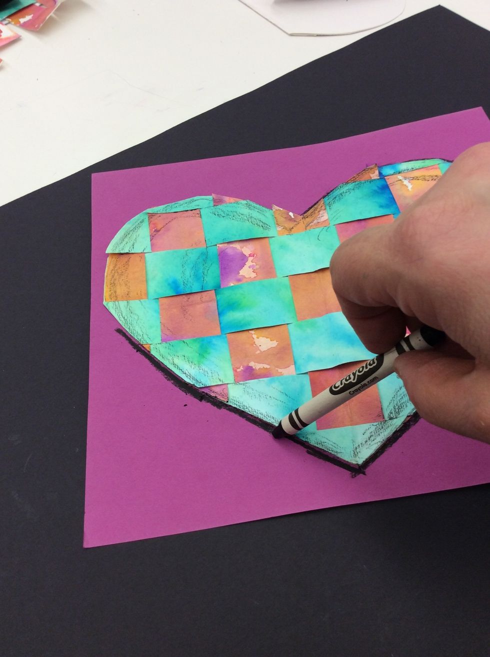 Place heart on the center of 9 x 9 construction paper. Using a black crayon, draw a shadow on the construction paper around the outline of heart.